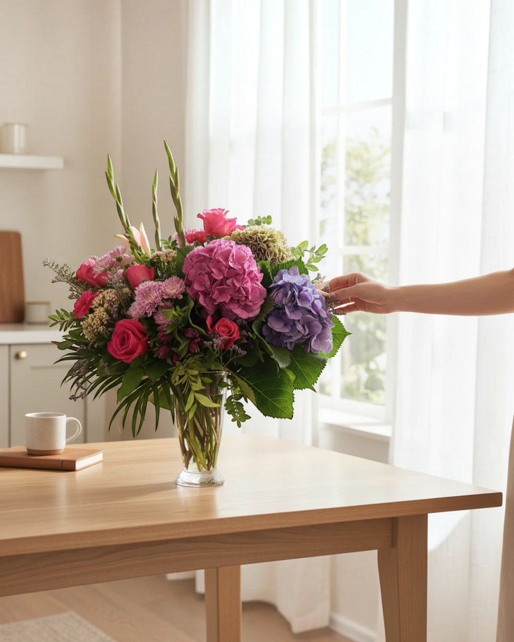 Lakewood Florist Sensational Summer Vase featuring a lush bouquet of pink roses and purple hydrangeas in a glass vase